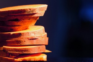 Sliced sweet potatoes against blue background