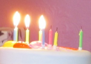 bright candles on a white cake