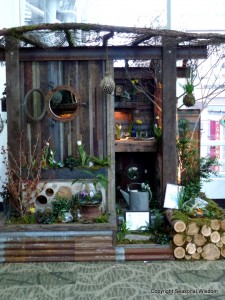 wooden shed with portholes and terrariums