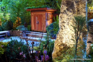 Zen-style garden at the Northwest Flower and Garden Show, with boulders, conifers, living roof and tiny wooden house