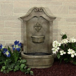 Solar garden fountain sits on porch surrounded by flowers