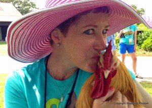 Guest in P. Allen Smith's garden kisses heritage poultry.