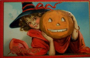 A cute little girl holds a jack o'lantern in this vintage halloween card