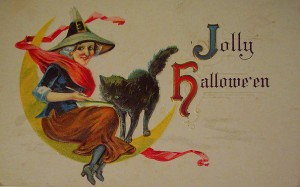 A witch flies on a moon in this vintage Halloween card