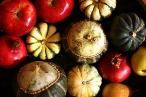 Gourds, apples and pomegranates are in this seasonal tablescape.