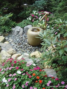 A simple fountain with rocks makes a nice power spot in the garden.