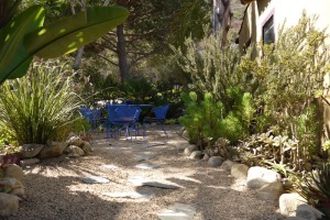 Water-wise garden with rocky path to outside table