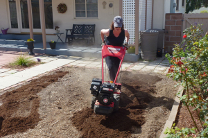 Woman using Troy-Bilt Bronco Axis Rototiller