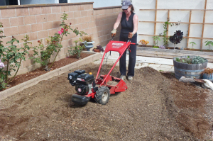 Woman uses Troy-Bilt Bronco Axis rototiller