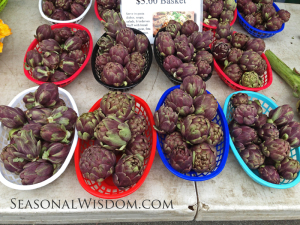 Purple artichokes for sale at farmers market