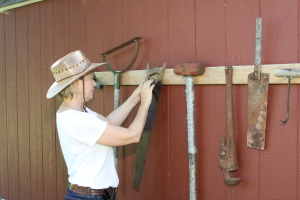 woman arranges garden tools